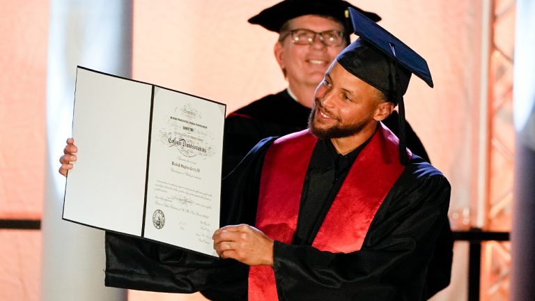 Golden State Warriors Stephen Curry poses with his diploma after his graduation ceremony at Davidson College on Wednesday, Aug. 31, 2022, in Davidson, N.C. Curry was also inducted into the school's Hall of Fame and his number and jersey were retired during the event. (Chris Carlson/AP)