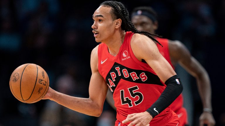 Toronto Raptors guard Dalano Banton brings the ball up the court against the Charlotte Hornets during the second half of an NBA basketball game in Charlotte, N.C., Monday, Feb. 7, 2022. (AP)