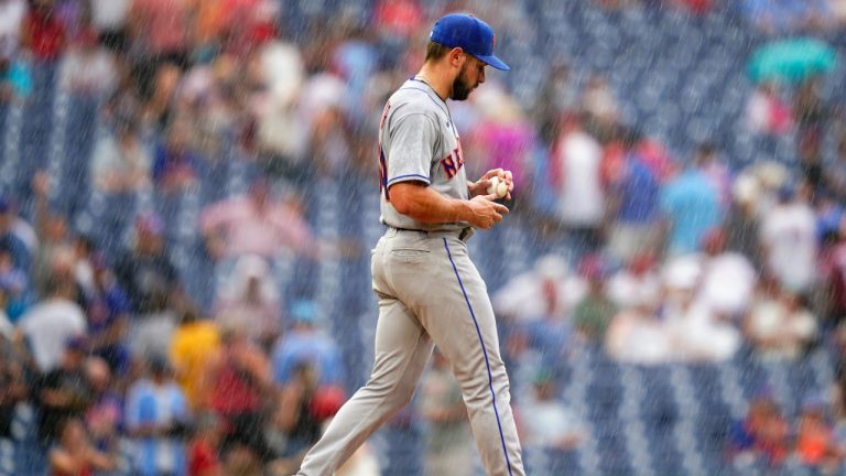 New York Mets pitcher Nate Fisher walks to the mound in a rain storm during the sixth inning of a baseball game against the Philadelphia Phillies, Sunday, Aug. 21, 2022, in Philadelphia. (Matt Slocum/AP)