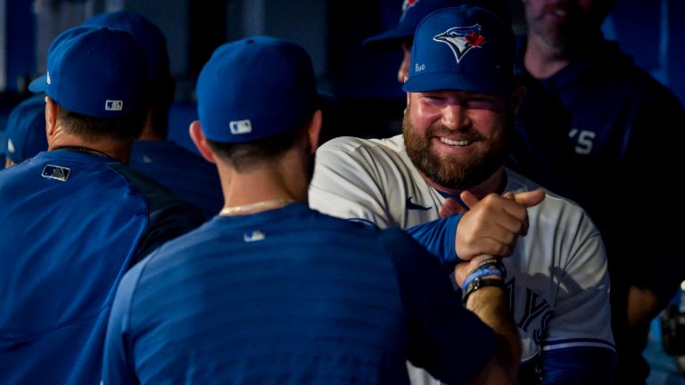 Toronto Blue Jays interim manager John Schneider (21) celebrates with team personnel after the Toronto Blue Jays defeated the Philadelphia Phillies 8-2 in nine innings of interleague MLB action against, in Toronto, on Wednesday, July 13, 2022. (Christopher Katsarov/CP)