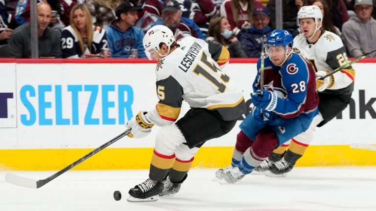 Vegas Golden Knights center Jake Leschyshyn, left, struggles to control the puck as Colorado Avalanche defenseman Ryan Murray pursues in the second period of an NHL hockey game Tuesday, Oct. 26, 2021, in Denver. (David Zalubowski/AP)