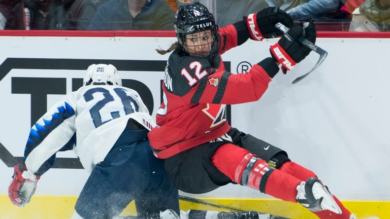 Team Canada's Meaghan Mikkelson fights for control of the puck with U.S.A.'s Kendall Coyne Schofield during first period of Women's Rivalry Series hockey action in Vancouver, Wednesday, February 5, 2020. (Jonathan Hayward/CP)