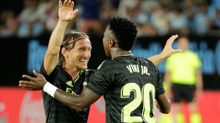 Real Madrid's Vinicius Junior, right, celebrates with Real Madrid's Luka Modric after scoring his side's third goal during a Spanish La Liga soccer match between Celta Vigo and Real Madrid at the Balaidos stadium in Vigo, Spain, Saturday, Aug. 20, 2022. (Lalo R. Villar/AP)