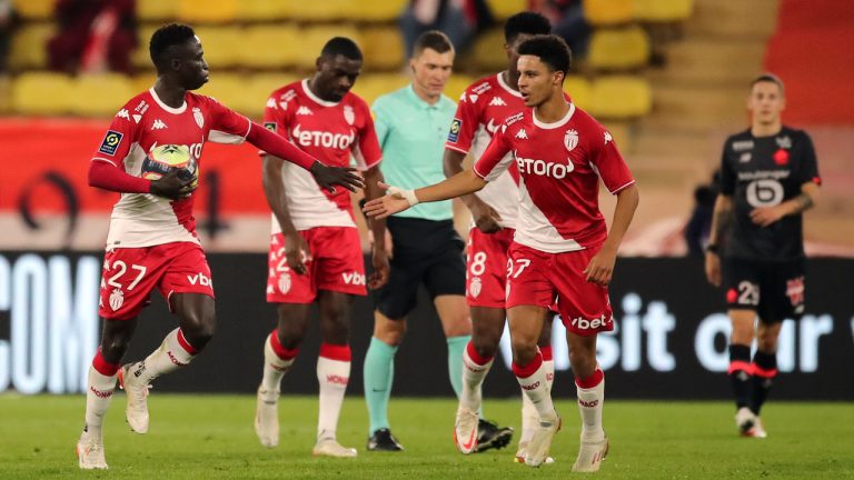 Monaco's Krepin Diatta, left, celebrates with teammates after scoring his side's opening goal during the French League One soccer match. (Daniel Cole/AP)