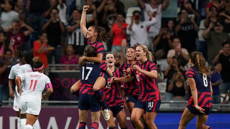 United States' Alex Morgan, top, is congratulated after scoring her side's opening goal from the penalty spot against Canada during the CONCACAF Women's Championship final soccer match in Monterrey, Mexico, Monday, July 18, 2022. (Fernando Llano/AP)