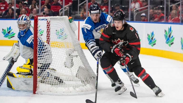 Canada's Ridly Greig (17) and Finland's Joni Jurmo (4) battle for the puck as goalie Leevi Merilainen (1) looks for the puck during second period IIHF World Junior Hockey Championship action in Edmonton on Monday August 15, 2022. (Jason Franson/CP)