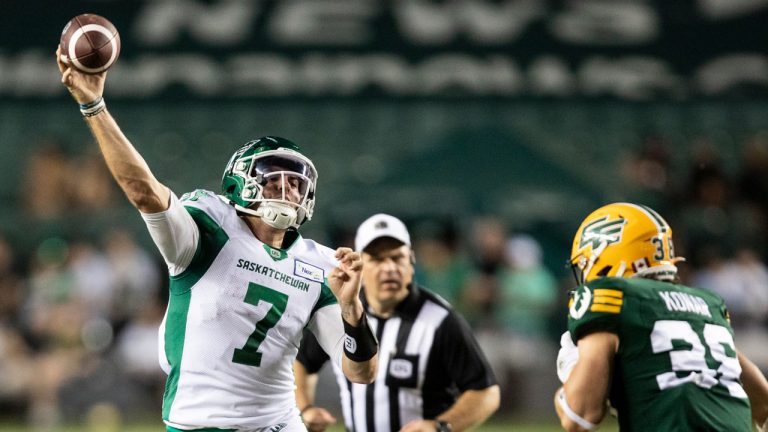 Saskatchewan Roughriders quarterback Cody Fajardo (7)throws downfield under pressure from Edmonton Elks linebacker Adam Konar (38) during first half CFL action. (Amber Bracken/CP)