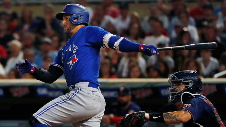 Toronto Blue Jays' George Springer watches his two-run single against the Minnesota Twins during the eighth inning of a baseball game Thursday, Aug. 4, 2022, in Minneapolis. (Bruce Kluckhohn/AP)