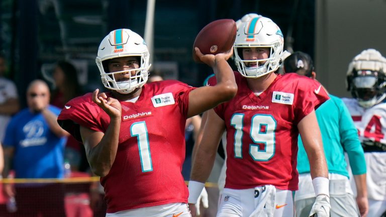 Miami Dolphins quarterback Tua Tagovailoa (1) throws a pass during an NFL football training camp practice with the Tampa Bay Buccaneers Wednesday, Aug. 10, 2022, in Tampa, Fla. Looking on is quarterback Skylar Thompson (19). (Chris O'Meara/AP)