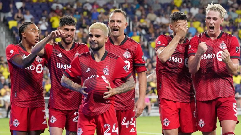 Toronto FC's Lorenzo Insigne (24) holds the ball under his shirt as he celebrates with his teammates after scoring a goal against Nashville SC during the second half of an MLS soccer match Saturday, Aug. 6, 2022, in Nashville, Tenn. (\Mark Humphrey/AP)