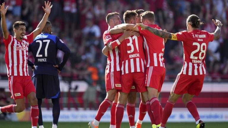 Union's scorer Robin Knoche, center, and his teammates celebrate their side's third goal during the German Bundesliga soccer match between 1. FC Union Berlin and Hertha BSC Berlin in Berlin. (Michael Sohn/AP)