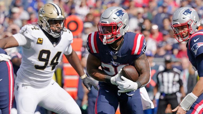 New England Patriots running back James White, centre, scrambles past New Orleans Saints defensive end Cameron Jordan (94) during the first half of an NFL football game, Sunday, Sept. 26, 2021, in Foxborough, Mass. (Steven Senne/AP)