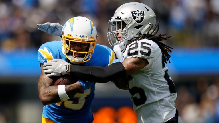 Los Angeles Chargers wide receiver Keenan Allen, left, runs after catching a pass against Las Vegas Raiders safety Tre'von Moehrig (25) during the first half of an NFL football game in Inglewood, Calif., Sunday, Sept. 11, 2022. (Marcio Jose Sanchez/AP Photo)