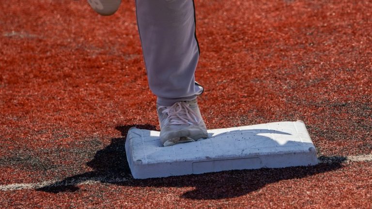 Larger bases are installed on the infield during a minor league baseball game between the Brooklyn Cyclones and Greensboro Grasshoppers. (John Minchillo/AP)