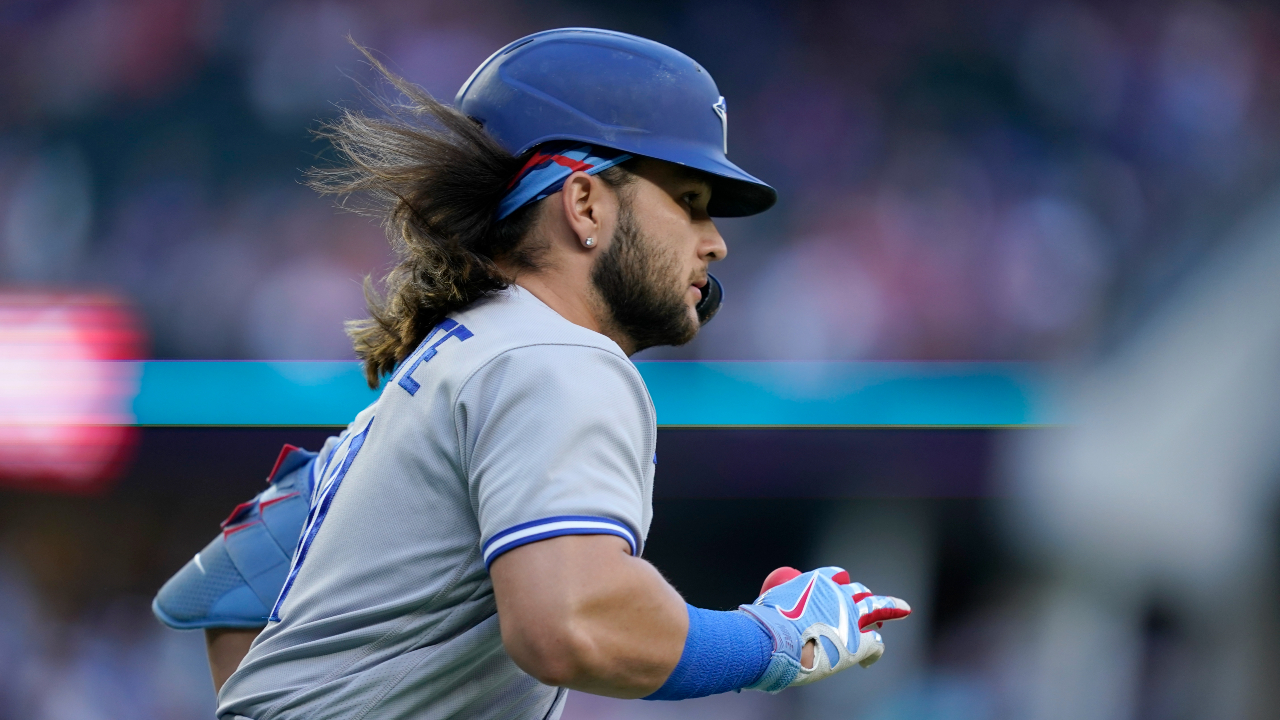 Bo Bichette of the Toronto Blue Jays flicks his hair back after