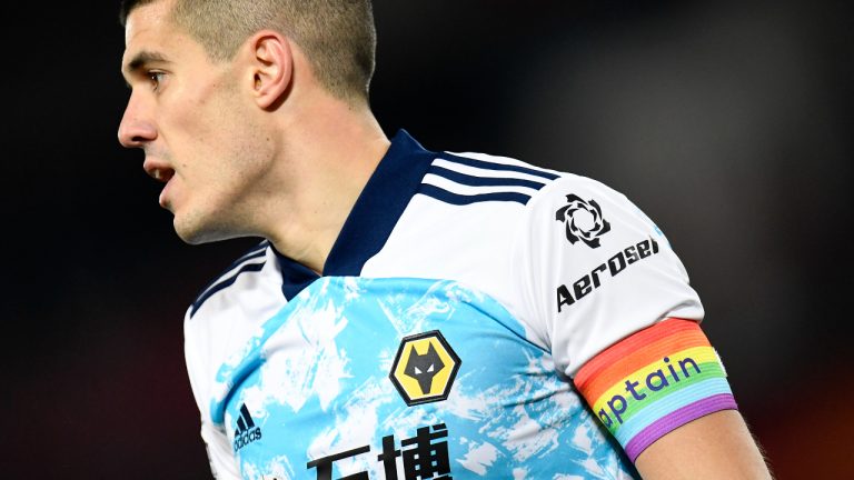 Wolverhampton Wanderers' Conor Coady wears a rainbow captain armband during the English Premier League soccer match between Liverpool and Wolverhampton Wanderers at Anfield Stadium, Liverpool, England, Sunday, Dec. 6, 2020. (Peter Powell/Pool via AP)