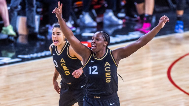 Las Vegas Aces guard Chelsea Gray (12) signals teammates with guard Kelsey Plum (10) nearby during the second half in Game 1 of a WNBA basketball final playoff series against the Connecticut Sun, Sunday, Sept. 11, 2022, in Las Vegas. (AP Photo/L.E. Baskow)