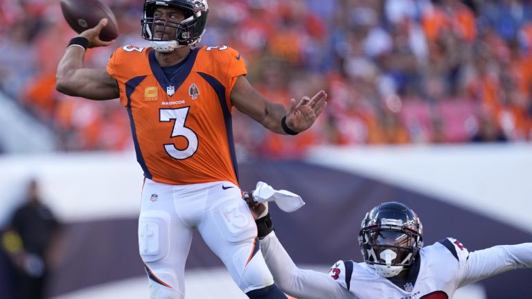 Denver Broncos quarterback Russell Wilson (3) is pressured by Houston Texans defensive end Jonathan Greenard (52) during the second half of an NFL football game, Sunday, Sept. 18, 2022, in Denver. (David Zalubowski/AP)