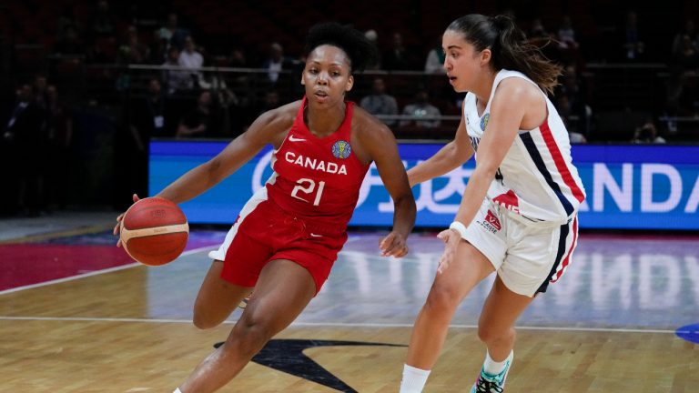 Canada's Nirra Fields, left, runs past France's Marine Fauthoux during their game at the women's Basketball World Cup. (Mark Baker/AP)