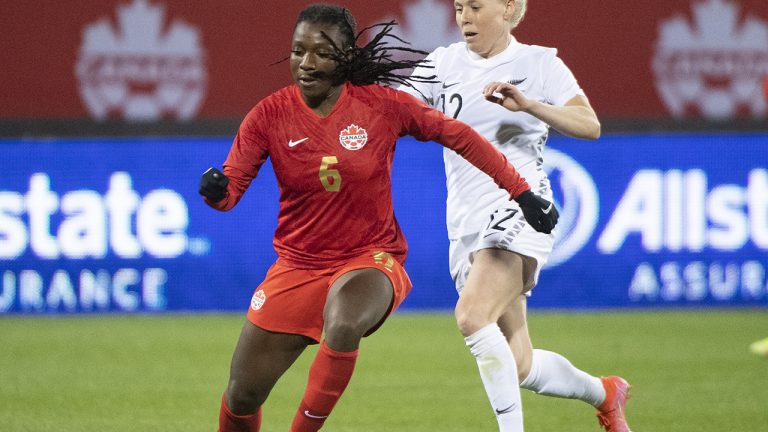 Canada’s Deanne Rose, left, breaks away from New Zealand’s Betsy Hassett during second half Celebration Tour soccer action in Montreal, Tuesday, October 26, 2021. (Graham Hughes/CP)