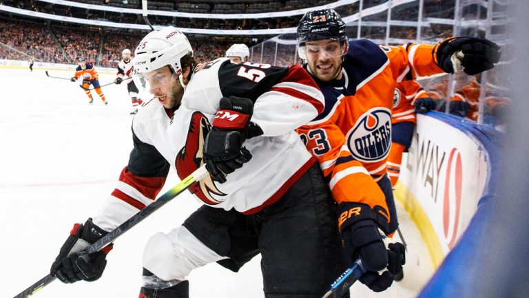 Arizona Coyotes' Jason Demers (55) and Edmonton Oilers' Riley Sheahan (23) battle for the puck during second period NHL action in Edmonton, Alta., on Saturday January 18, 2020. (Jason Franson/THE CANADIAN PRESS)