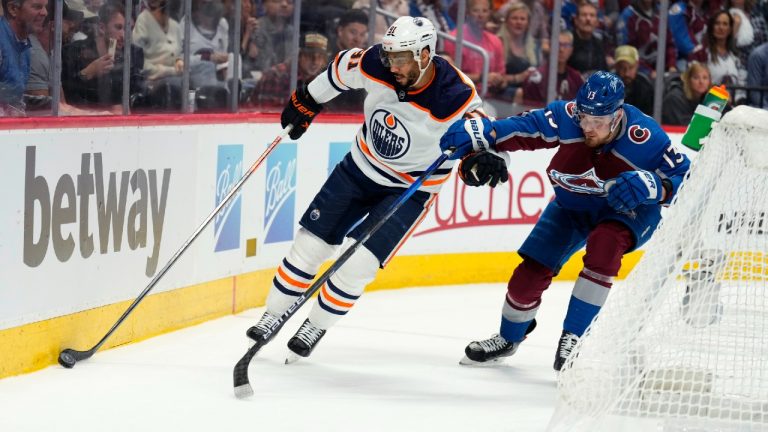 Edmonton Oilers left wing Evander Kane (91) and Colorado Avalanche right wing Valeri Nichushkin (13) skate behind the net during the first period in Game 2 of the NHL hockey Stanley Cup playoffs Western Conference finals Thursday, June 2, 2022, in Denver. (Jack Dempsey/AP)