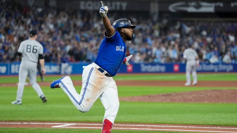 Toronto Blue Jays first baseman Vladimir Guerrero Jr. (27) celebrates as he rounds the bases after hitting the game winning RBI single against the New York Yankees during tenth inning American League MLB baseball action in Toronto on Monday, September 26, 2022. (Nathan Denette/CP)