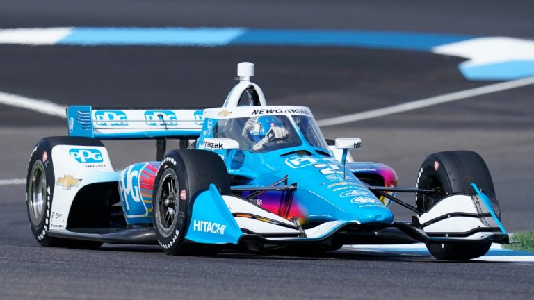 Josef Newgarden drives into a turn during a practice session for a IndyCar auto race at Indianapolis Motor Speedway, Friday, July 29, 2022, in Indianapolis. (Darron Cummings/AP)