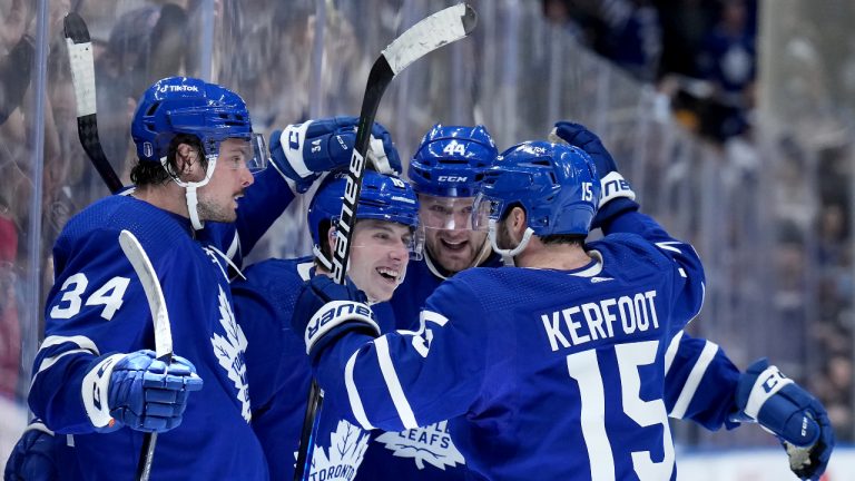 Toronto Maple Leafs forward Mitchell Marner (16) celebrates his goal with teammates Auston Matthews (34), Morgan Rielly (44) and Alexander Kerfoot (15) during second period, round one, NHL Stanley Cup playoff hockey action against the Tampa Bay Lightning, in Toronto, Monday, May 2, 2022. (Nathan Denette/CP)