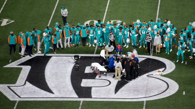 Teammates gather around Miami Dolphins quarterback Tua Tagovailoa (1) after an injury during the first half of an NFL football game against the Cincinnati Bengals, Thursday, Sept. 29, 2022, in Cincinnati. (Emilee Chinn/AP)