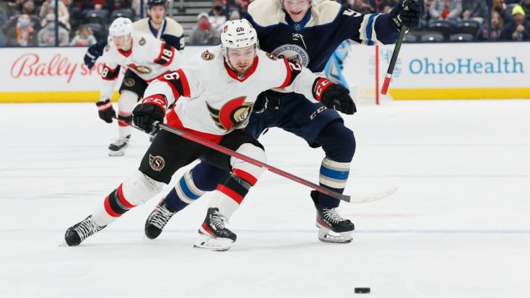 Ottawa Senators' Erik Brannstrom, left, and Columbus Blue Jackets' Eric Robinson chase the puck during the second period of an NHL hockey game Sunday, Jan. 23, 2022, in Columbus, Ohio. (Jay LaPrete/AP)