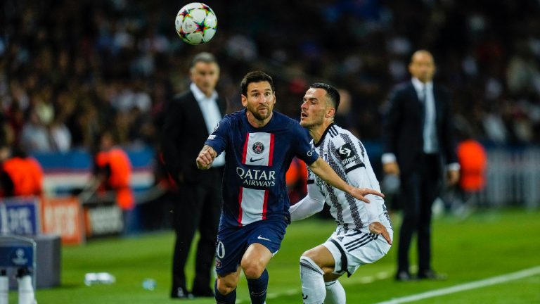 PSG's Lionel Messi, left, duels for the ball with Juventus' Filip Kostic during the Champions League soccer match Group H at the Parc des Princes stadium, in Paris, Tuesday, Sept. 6, 2022. (Thibault Camus/AP)