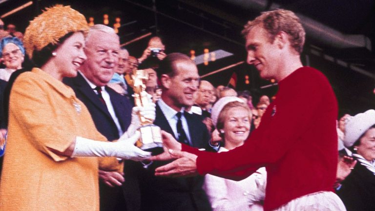 FILE - In this July 30, 1966 file photo Queen Elizabeth II presents the World Cup, the Jules Rimet trophy, to England's team captain Bobby Moore. England beat Germany in the final at London's Wembley Stadium by 4 goals to two, after extra time. (AP Photo)