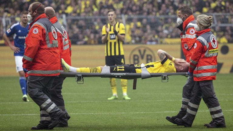 Dortmund's Marco Reus is carried off the pitch during the German Bundesliga soccer match between Borussia Dortmund and FC Schalke 04 in Dortmund, Germany, Saturday, Sept. 19, 2022. (Bernd Thissen/dpa via AP)