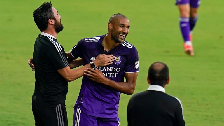 Orlando City forward Tesho Akindele, center, celebrates with coaches after scoring a goal against Toronto FC during the first half of an MLS soccer match, Saturday, May 22, 2021, in Orlando, Fla. (John Raoux/AP)