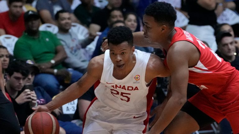 Canada's Trae Bell-Haynes, left, dribbles against Panama's Jose Montenegro, during a basketball WCup America's qualifying match at the Roberto Duran Arena in Panama City, Monday, Aug. 29, 2022. Canada won 106-50. (Arnulfo Franco/AP)