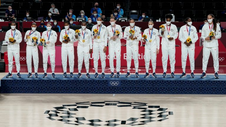 United States players pose with their gold medals during the medal ceremony for women's basketball at the 2020 Summer Olympics, Sunday, Aug. 8, 2021, in Saitama, Japan. (Charlie Neibergall/AP)