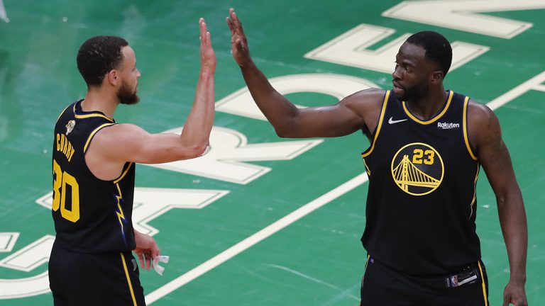 Golden State Warriors guard Stephen Curry (30) and forward Draymond Green (23) high five during the fourth quarter of Game 4 of basketball's NBA Finals against the Boston Celtics, Friday, June 10, 2022, in Boston. (Michael Dwyer/AP)