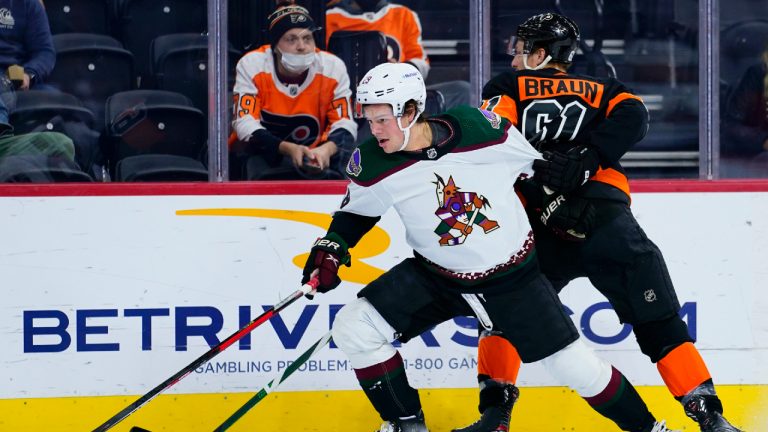 Arizona Coyotes' Barrett Hayton, left, tries to get pst Philadelphia Flyers' Justin Braun during the first period of an NHL hockey game, Tuesday, Nov. 2, 2021, in Philadelphia. (Matt Slocum/AP)