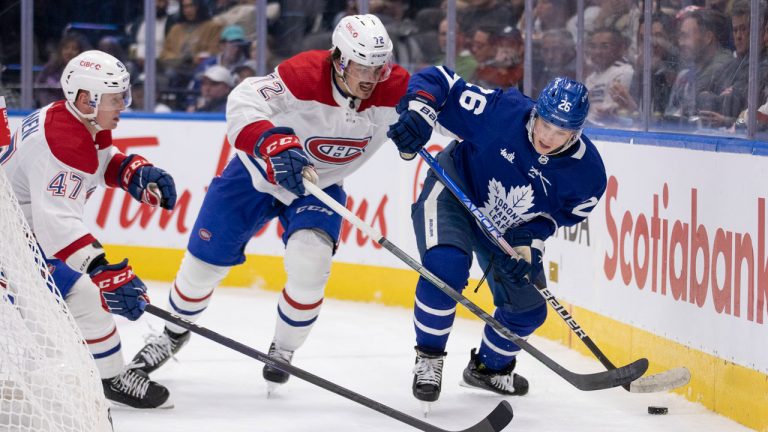 Nicholas Abruzzese (26) of the Toronto Maple Leafs fights for a puck with Arber Xhekaj (72) of the Montreal Canadiens during second period NHL preseason action. (Nick Iwanyshyn/CP)