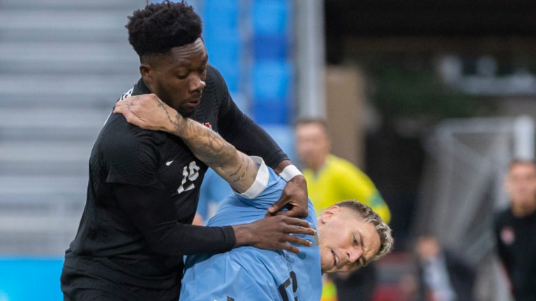 Canada's Alphonso Davies, left, and Uruguay's Agustin Rogel battle for the ball during the international friendly soccer match between Canada and Uruguay in Bratislava, Slovakia, Tuesday, Sept. 27, 2022. (Martin Baumann/TASR via AP) 