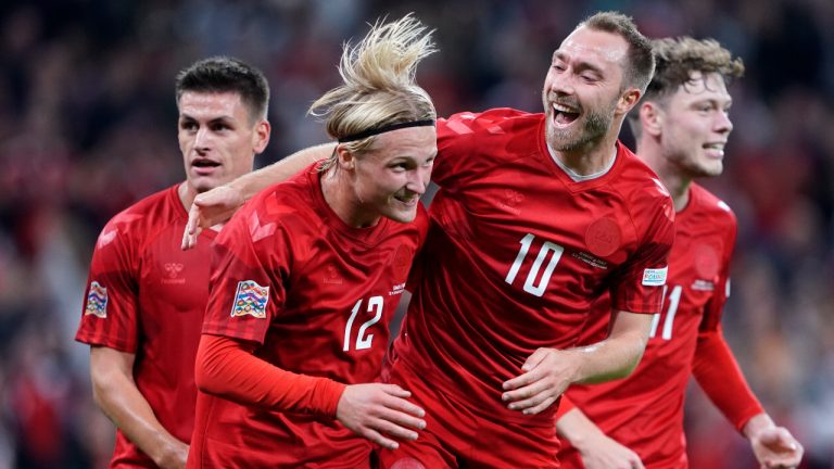 Denmark's Kasper Dolberg, second left, celebrates scoring with teammates Christian Eriksen, center right, Joachim Maehle and Andreas Skov Olsen, right, during the UEFA Nations League soccer match between Denmark and France at Parken Stadium in Copenhagen, Denmark, Sunday Sept. 25, 2022. (Liselotte Sabroe/Ritzau Scanpix via AP)