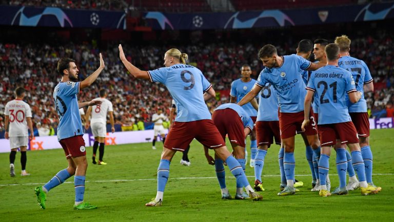 Manchester City's Erling Haaland celebrates with Manchester City's Bernardo Silva after scoring his side's third goal during the group G Champions League soccer match between Sevilla and Manchester City in Seville, Spain, Tuesday, Sept. 6, 2022. (Jose Breton/AP)