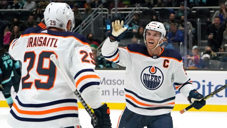 Edmonton Oilers' Connor McDavid reacts to a goal by the team with Leon Draisaitl (29) against the Seattle Kraken in the first period of an NHL hockey game Saturday, Dec. 18, 2021, in Seattle. (Elaine Thompson/AP)