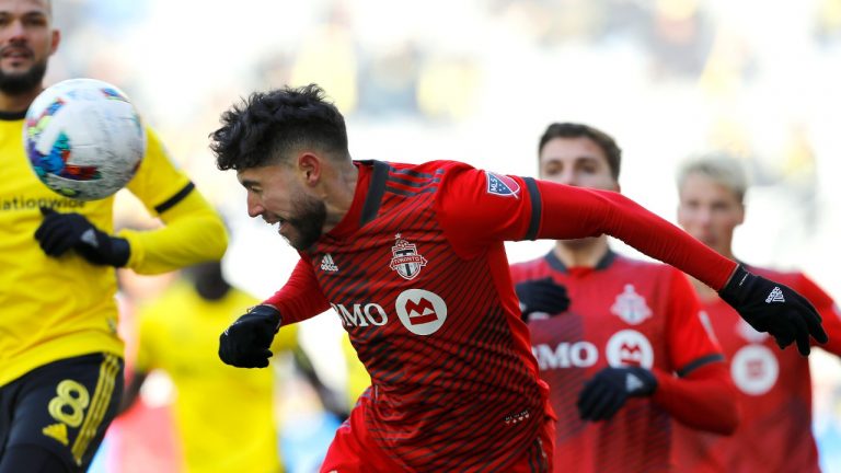 Toronto FC midfielder Jonathan Osorio heads the ball during the second half of an MLS soccer match against the Columbus Crew on Saturday, March 12, 2022, in Columbus, Ohio. (Joe Maiorana/AP)