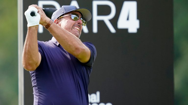 Phill Mickelson watches his tee shot on the 12th hole during the first round of the LIV Golf Invitational-Chicago tournament Friday, Sept. 16, 2022, in Sugar Grove, Ill. (AP Photo/Charles Rex Arbogast) 