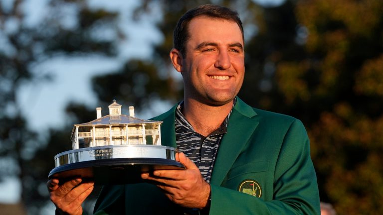 Scottie Scheffler holds the championship trophy after winning the 86th Masters golf tournament on Sunday, April 10, 2022, in Augusta, Ga. (David J. Phillip/AP) 