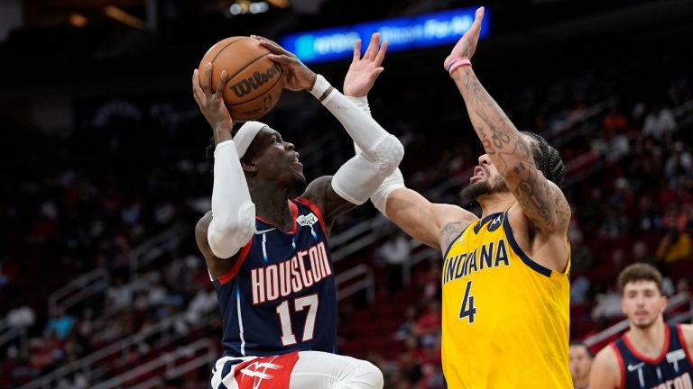 Houston Rockets' Dennis Schroder (17) goes up for a shot as Indiana Pacers' Duane Washington Jr. (4) defends during the second half of an NBA basketball game Friday, March 18, 2022, in Houston.The Pacers won 121-118. (David J. Phillip/AP)