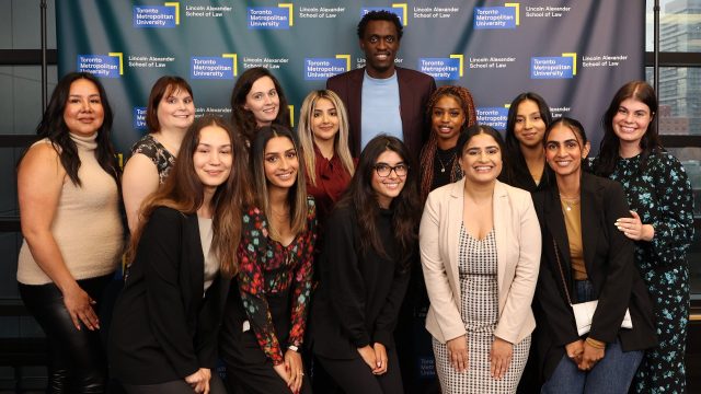 Pascal Siakam (back) meets with the 12 internship recipients at Toronto Metropolitan University's Lincoln Alexander School of Law. (Photo Credit: Toronto Metropolitan University)