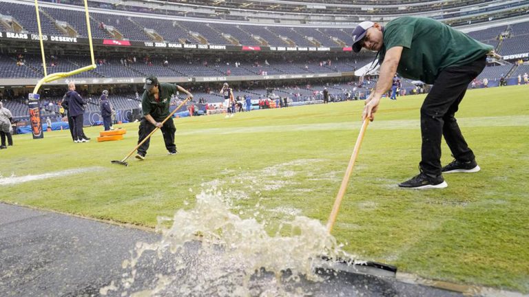 Workers remove water from Soldier Field before an NFL football game between the Chicago Bears and the San Francisco. (Charles Rex Arbogast/AP)